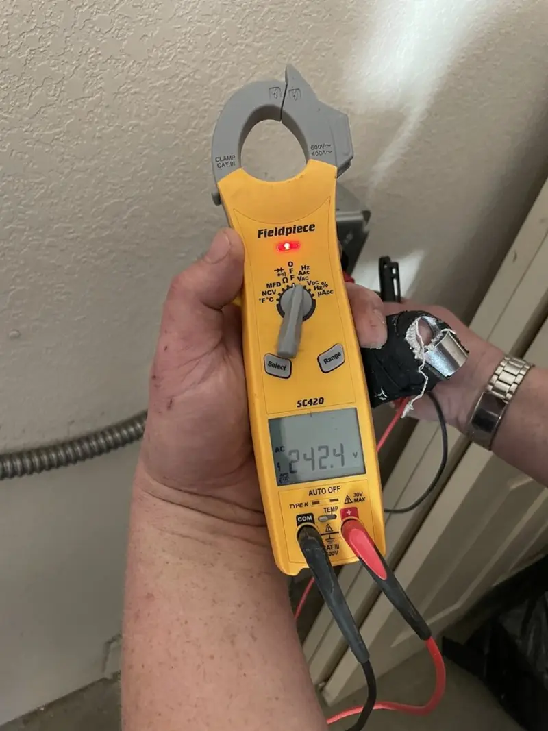 Voltage testing with clamp meter during Recessed Lighting Installation in North Dansville